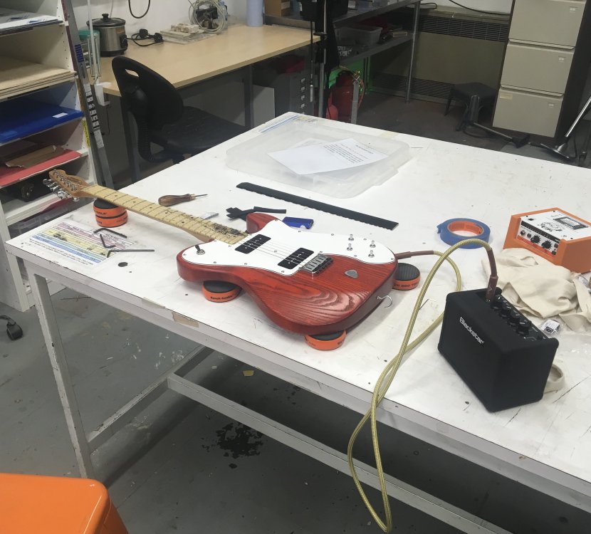 A guitar sits on the workbench, plugged into the Blackstar Fly amp. The old Orange Mini Crush sits unloved in the background.
