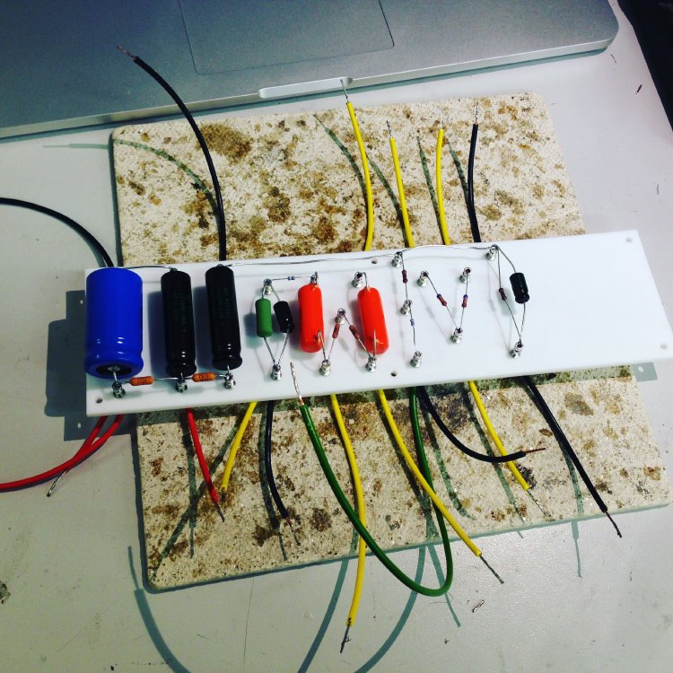 A photo of the main turret board/circuit board for the amp, with all the components soldered on and wires sticking out of ready to connect to other things.