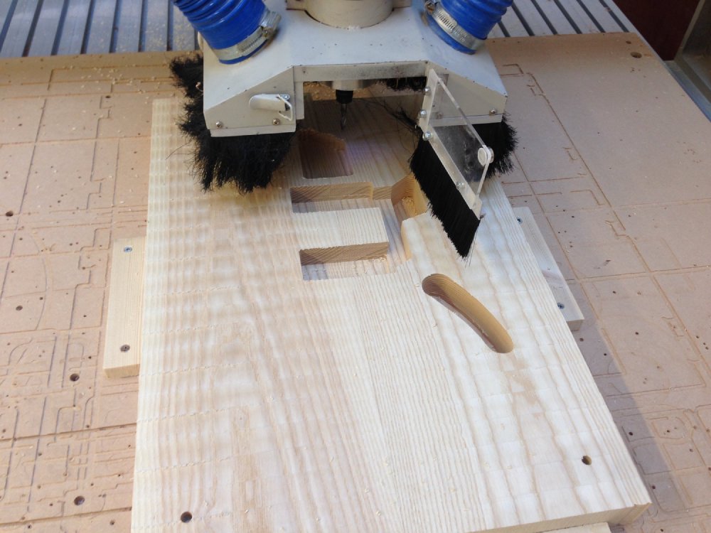An block of wood starts to look like a guitar body as the CNC-router cuts the cavities for the pickups and electronics.
