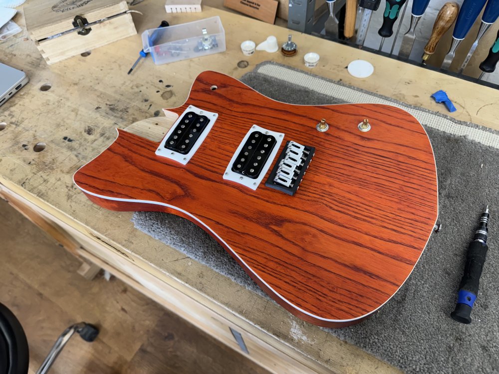 Another photo of the guitar body, but this time both pickups are properly mounted in place.
